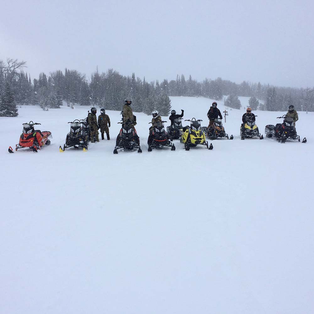 big group of riders snowmobiling in montana