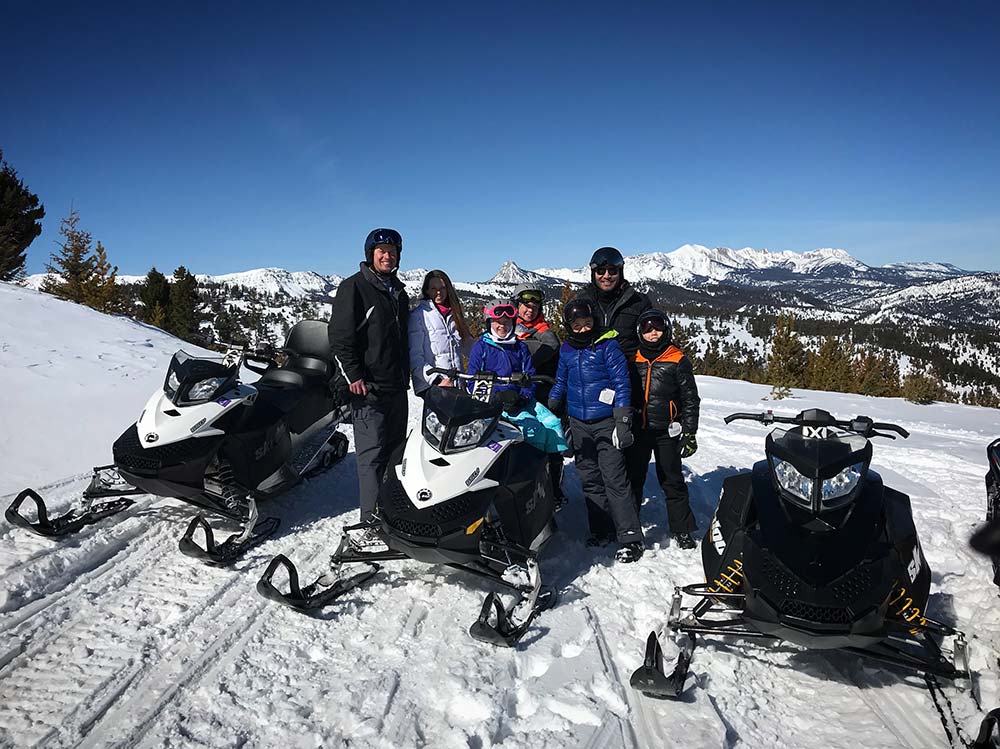 three snowmobilers trail riding in montana