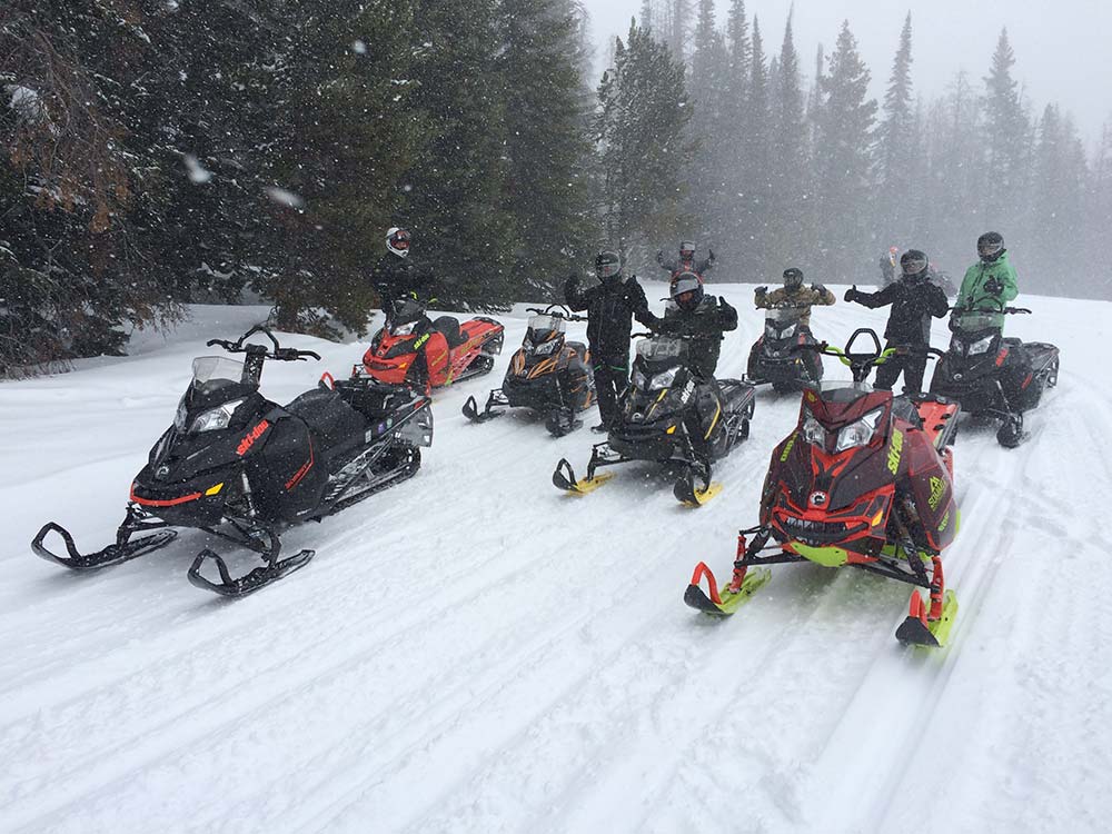 team of riders going snowmobiling in montana