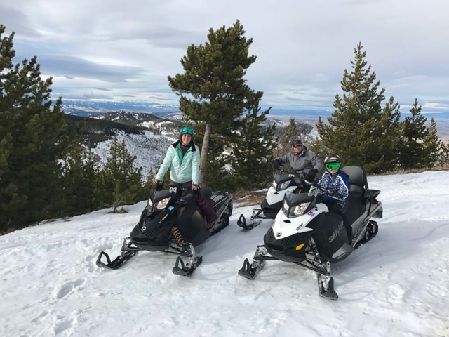 two riders high snowmobiling in montana
