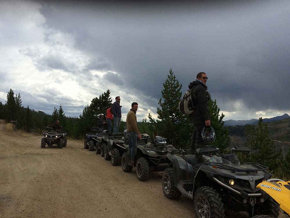 ATV trail riders in montana with stormy clouds