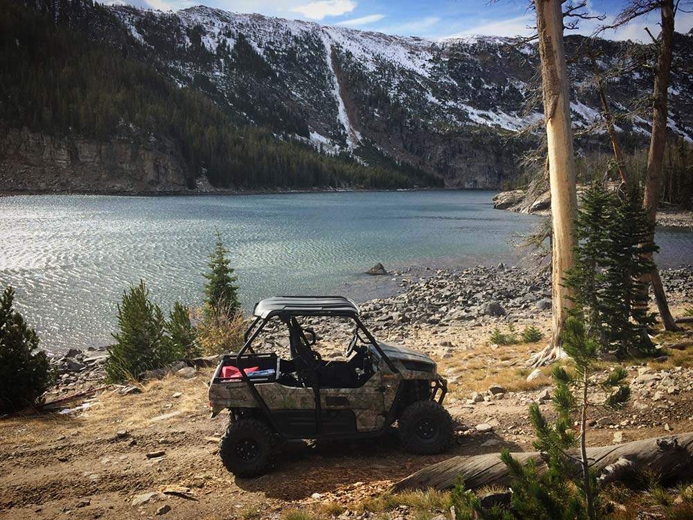 Side by side on the trail with lake behind in Montana