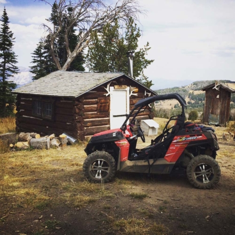 side by side trail riding in montana with barn behind
